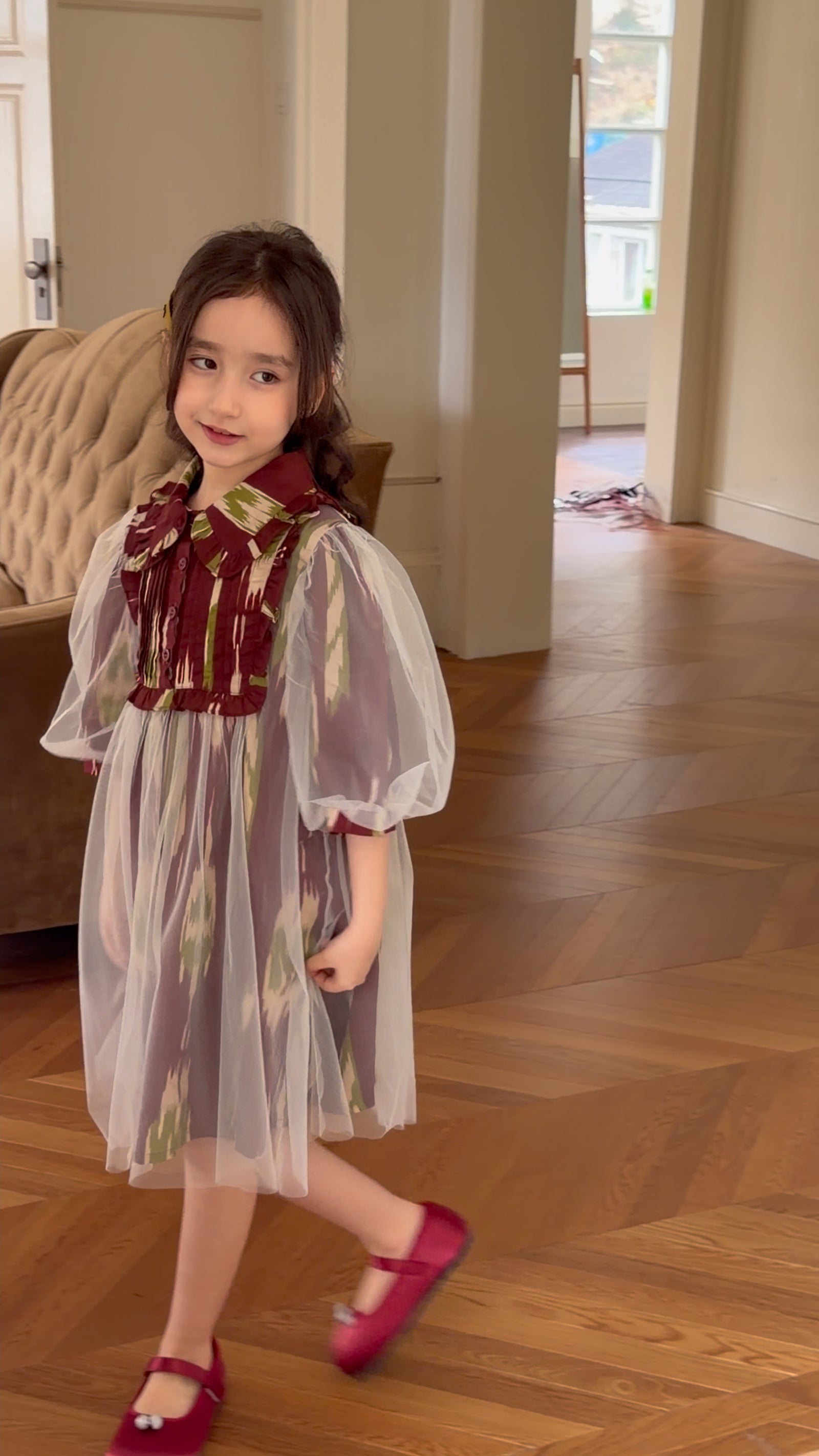 Girl wearing a colorful Liwanay statement dress for everyday wear and special little moments.