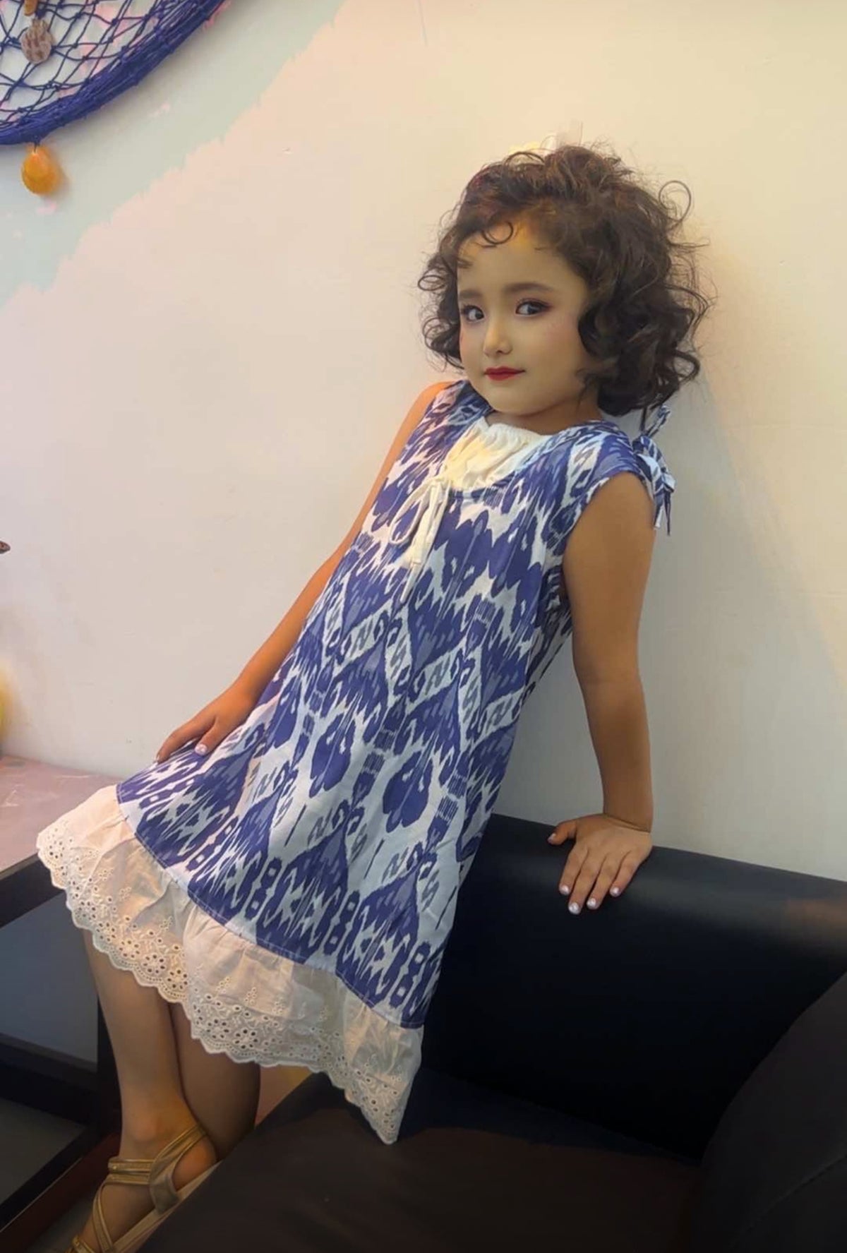 Child wearing colorful Liwanay kidswear in a real family moment