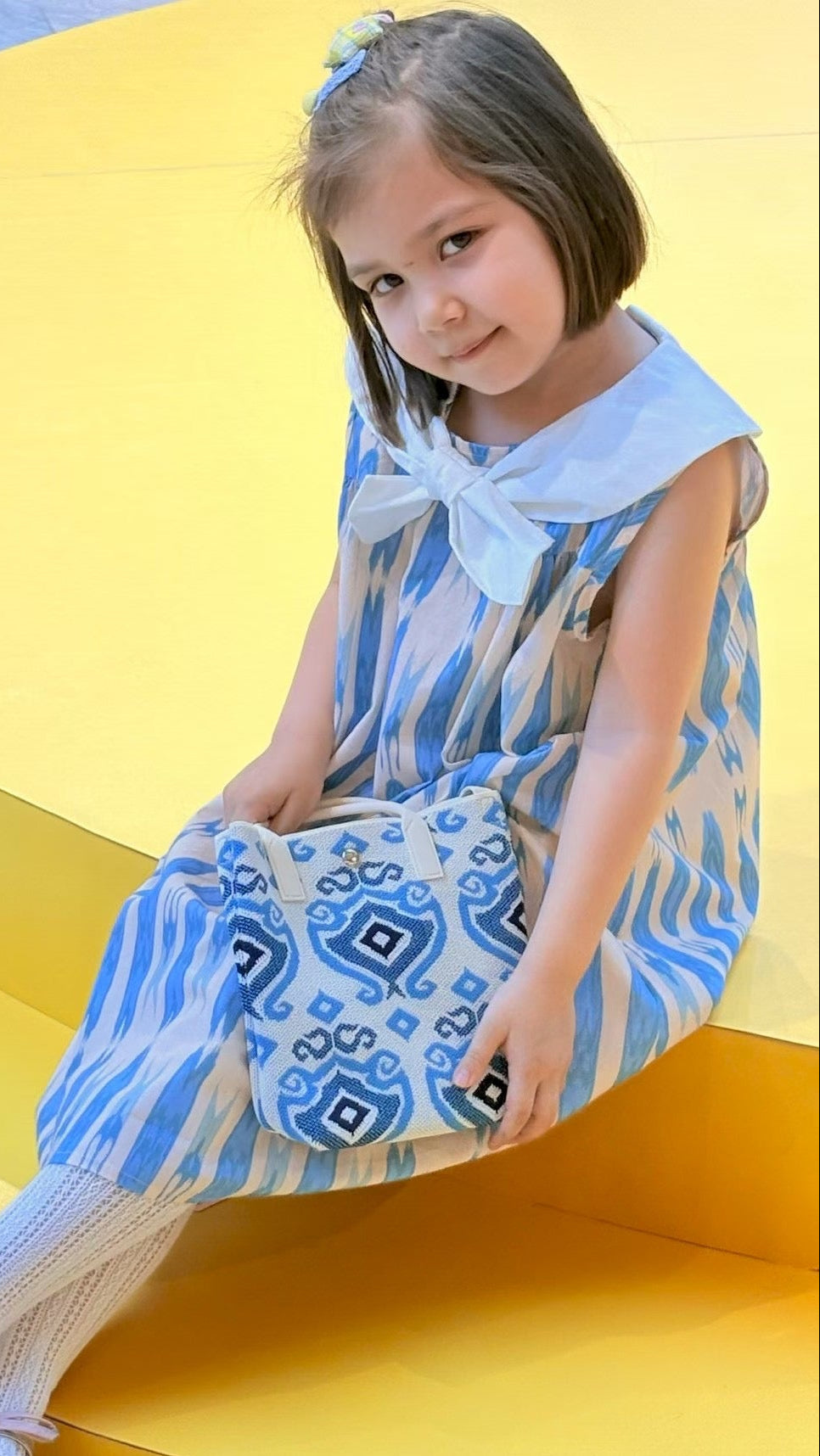 Child wearing colorful Liwanay kidswear in a real family moment