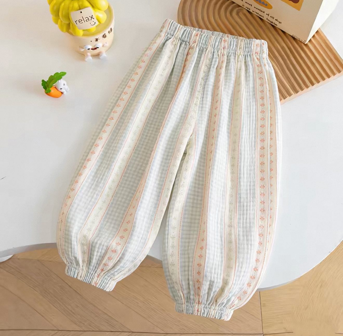 Striped pants on a white background with a smartphone interface at the top.