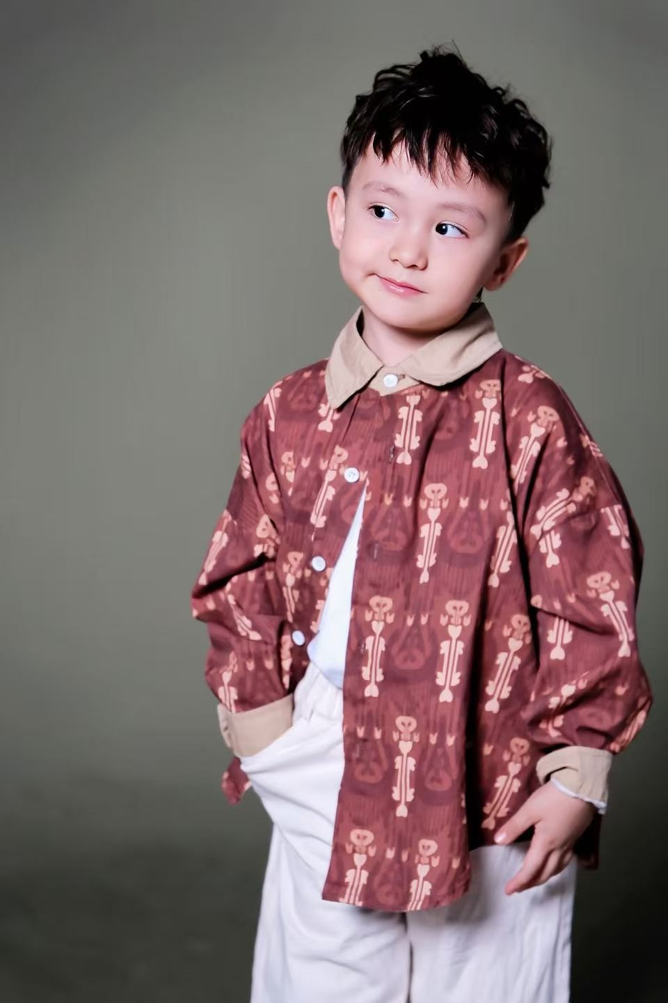 Child wearing colorful Liwanay kidswear in a real family moment