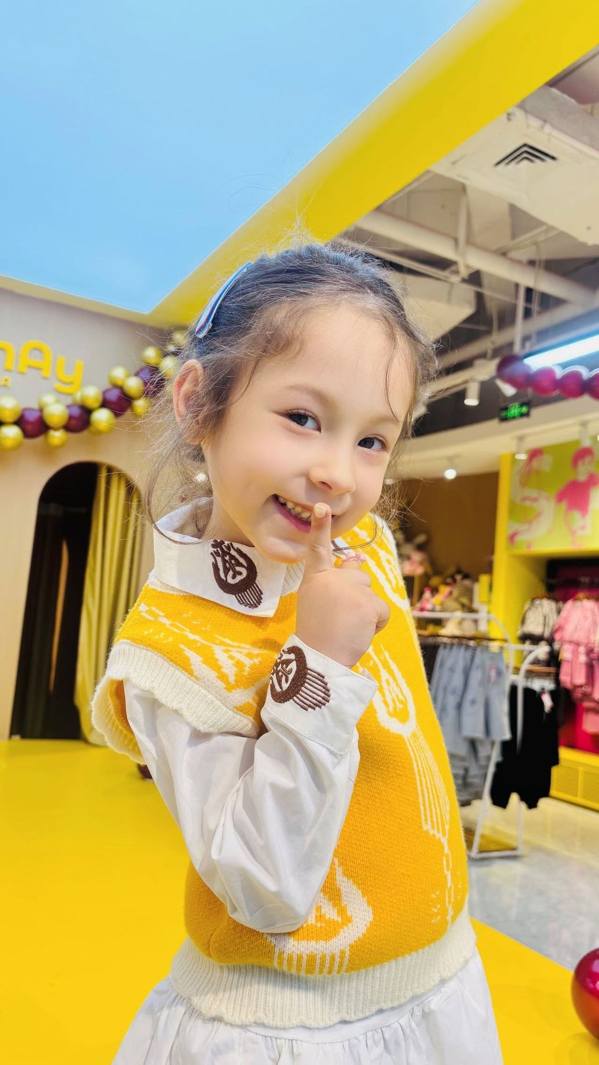 Child wearing colorful Liwanay kidswear in a real family moment